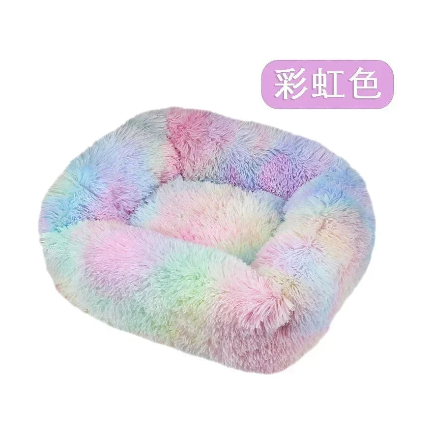 Soft fluffy pastel rainbow-colored pet bed with raised edges on white background