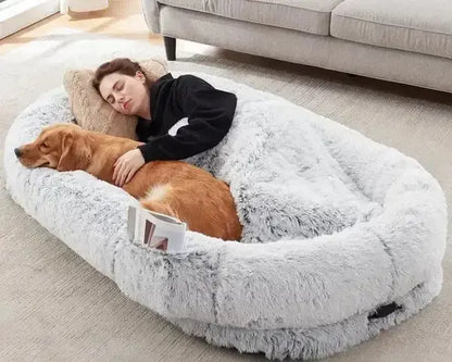Woman and golden retriever napping together on grey orthopedic human dog bed