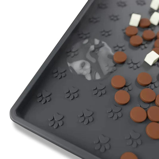 Non-slip Silicone Pet Feeding Mat with paw print design, featuring scattered pet treats, ideal for mess-free feeding.