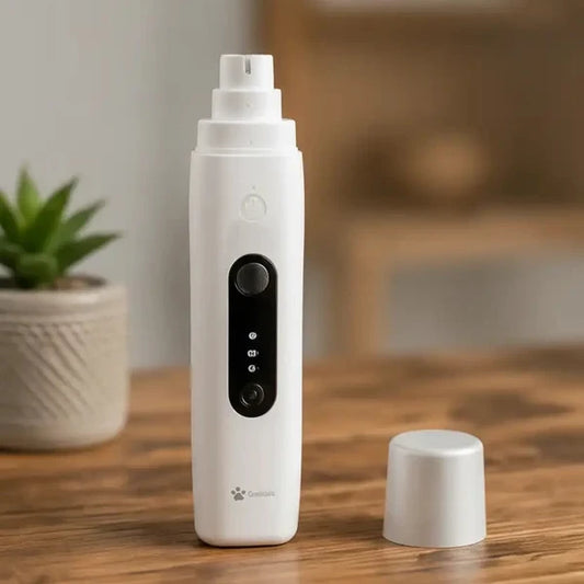 A white handheld beauty device with a black control panel stands on a wooden table, with its cap placed beside it. The background is a softly blurred indoor setting with a small potted plant and warm-toned decor.